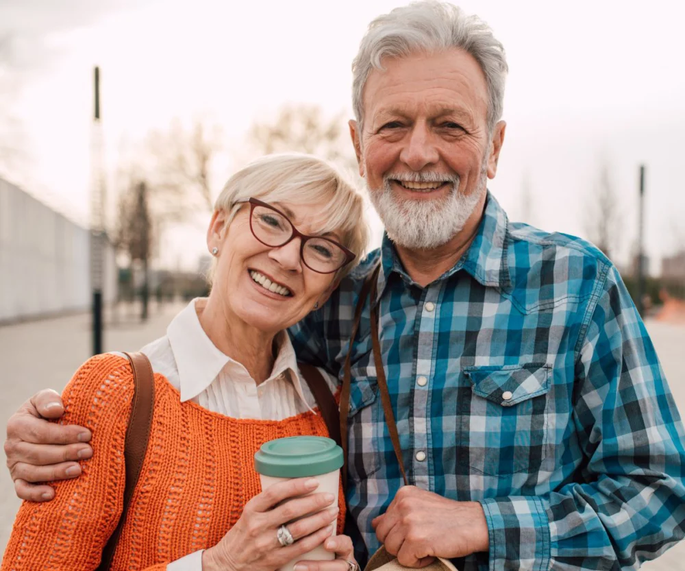 Couple Smiling With Dental Implants