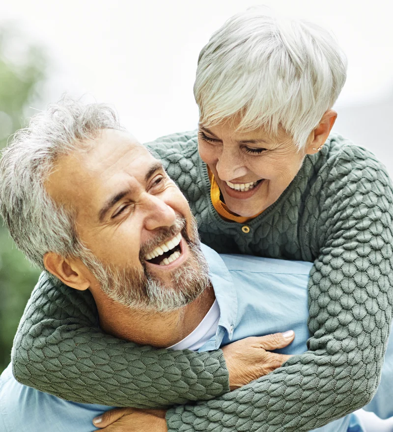 Older Couple Smiling After Dental Implants