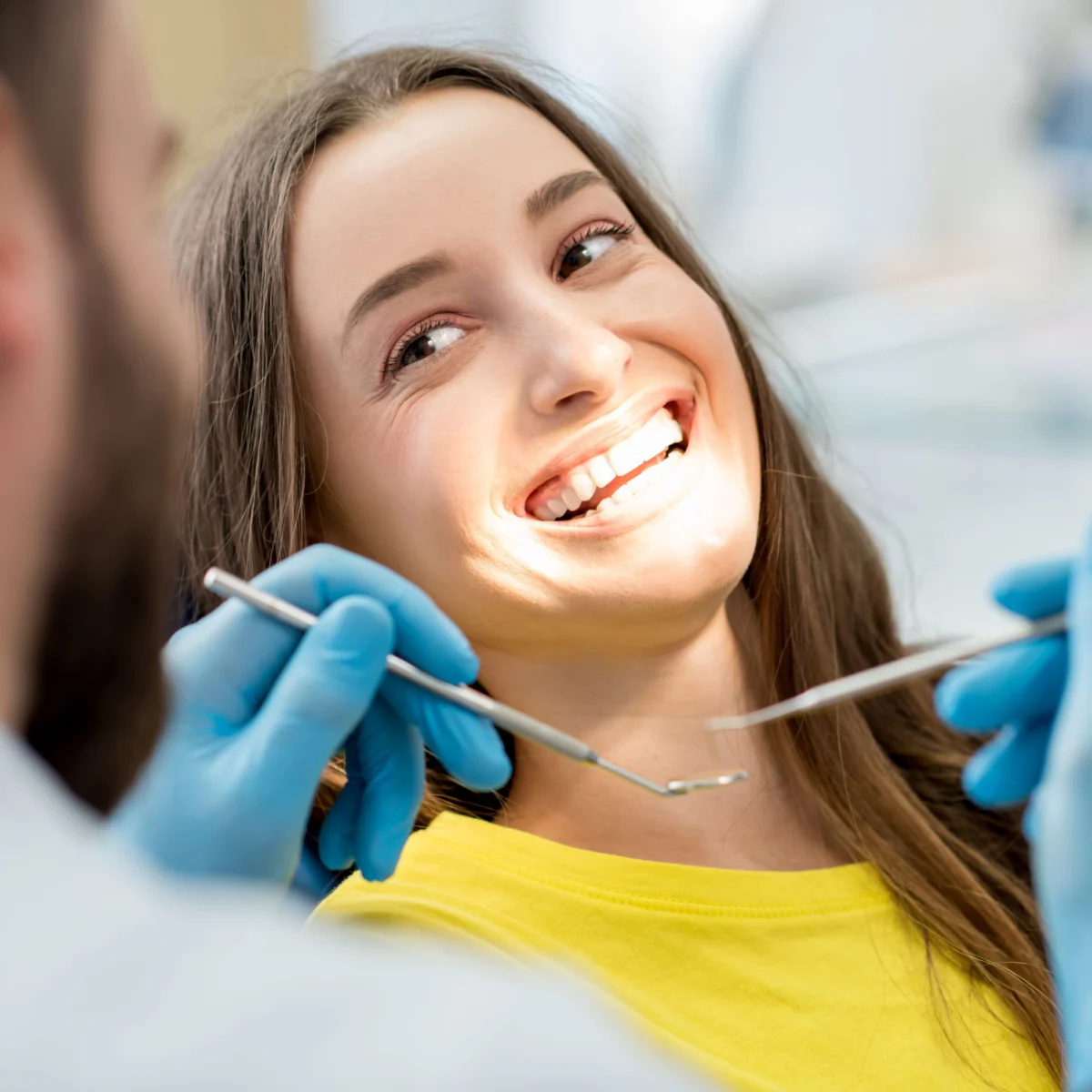Happy Dental Patient Smiling In Dental Chair
