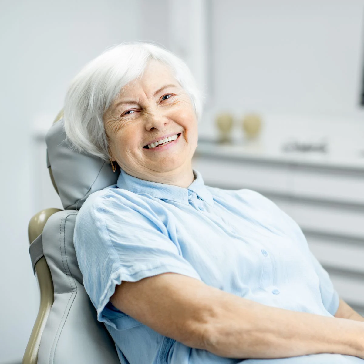 Woman Smiling With Implant-Supported Dentures