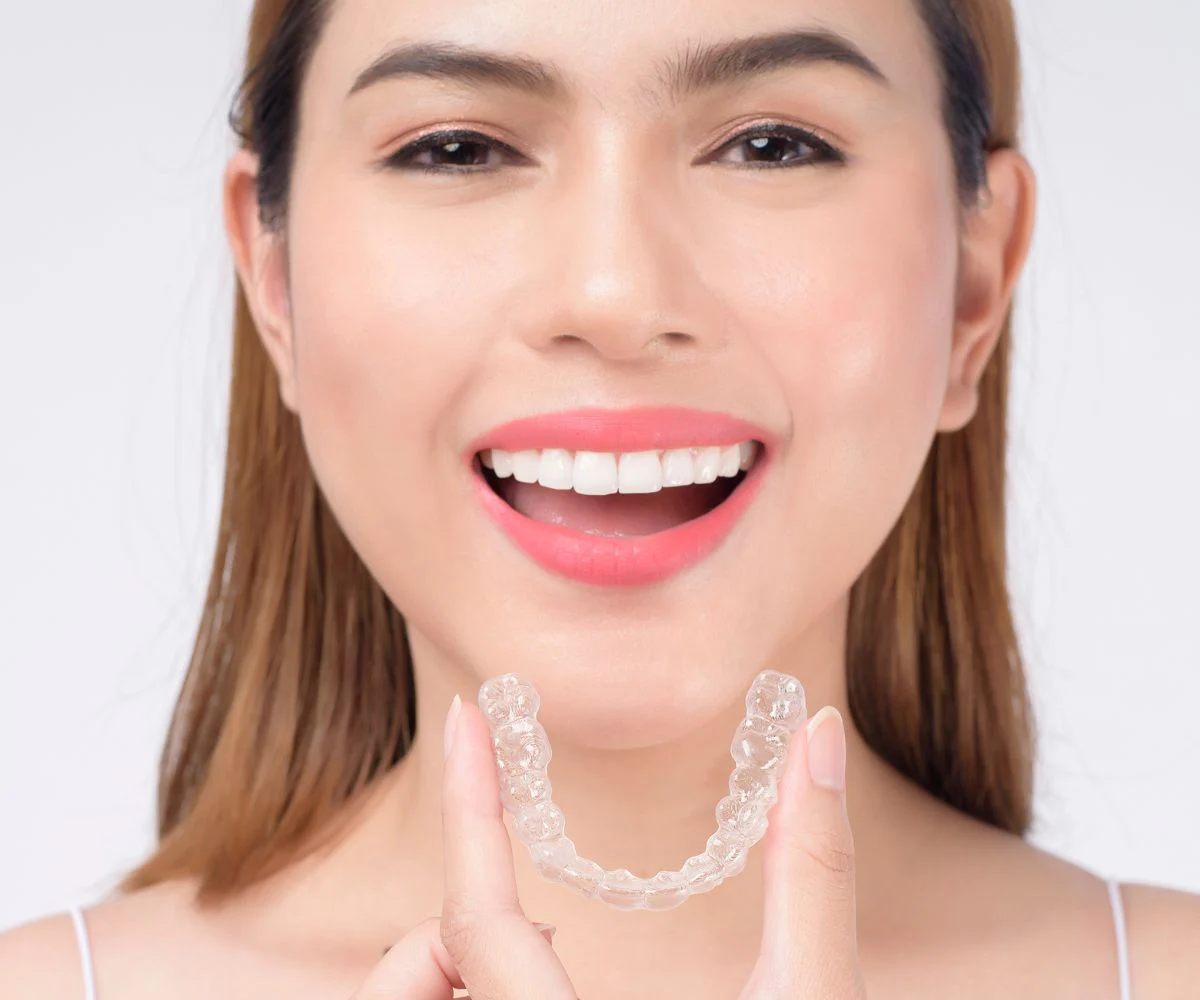 Woman Smiling With Invisalign Tray