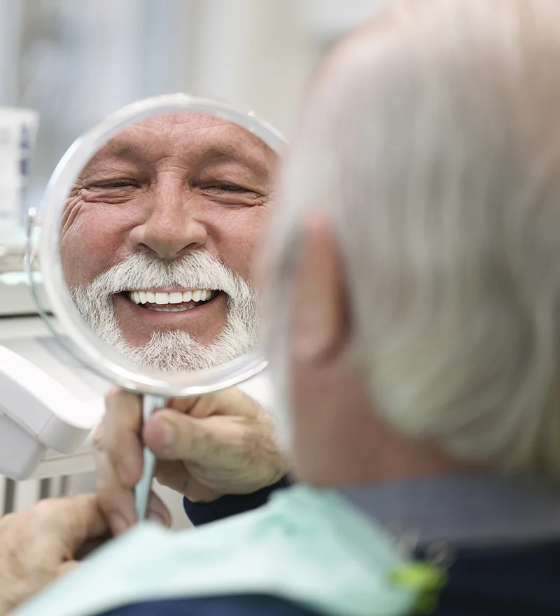 Man Smiling After Full Mouth Dental Implants Placement